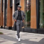 Fashion Man Wearing Fashionable Clothes gray coat animal print, turtleneck, cap, trousers and white