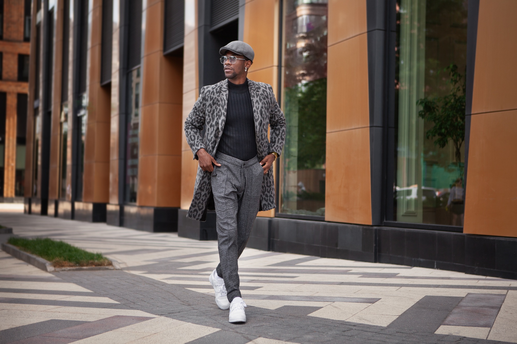 Fashion Man Wearing Fashionable Clothes gray coat animal print, turtleneck, cap, trousers and white