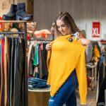 Overweight woman trying on clothes in a clothing store in the plus size section